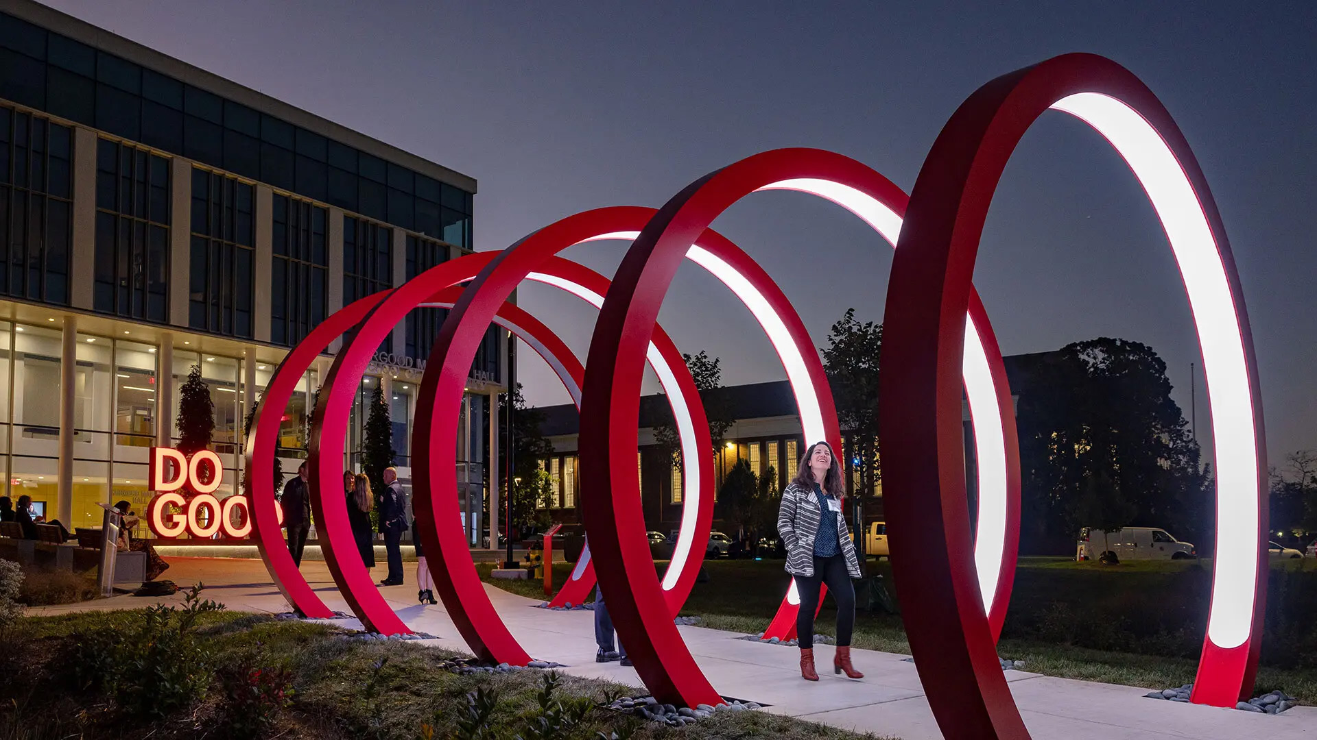 Brandy Espinola, climate resilience and sustainability program director at UMD’s Environmental Finance Center, steps through the new 12-foot Do Good Rings outside Thurgood Marshall Hall after Thursday’s ribbon-cutting ceremony. Photo by Stephanie S. Cordle.