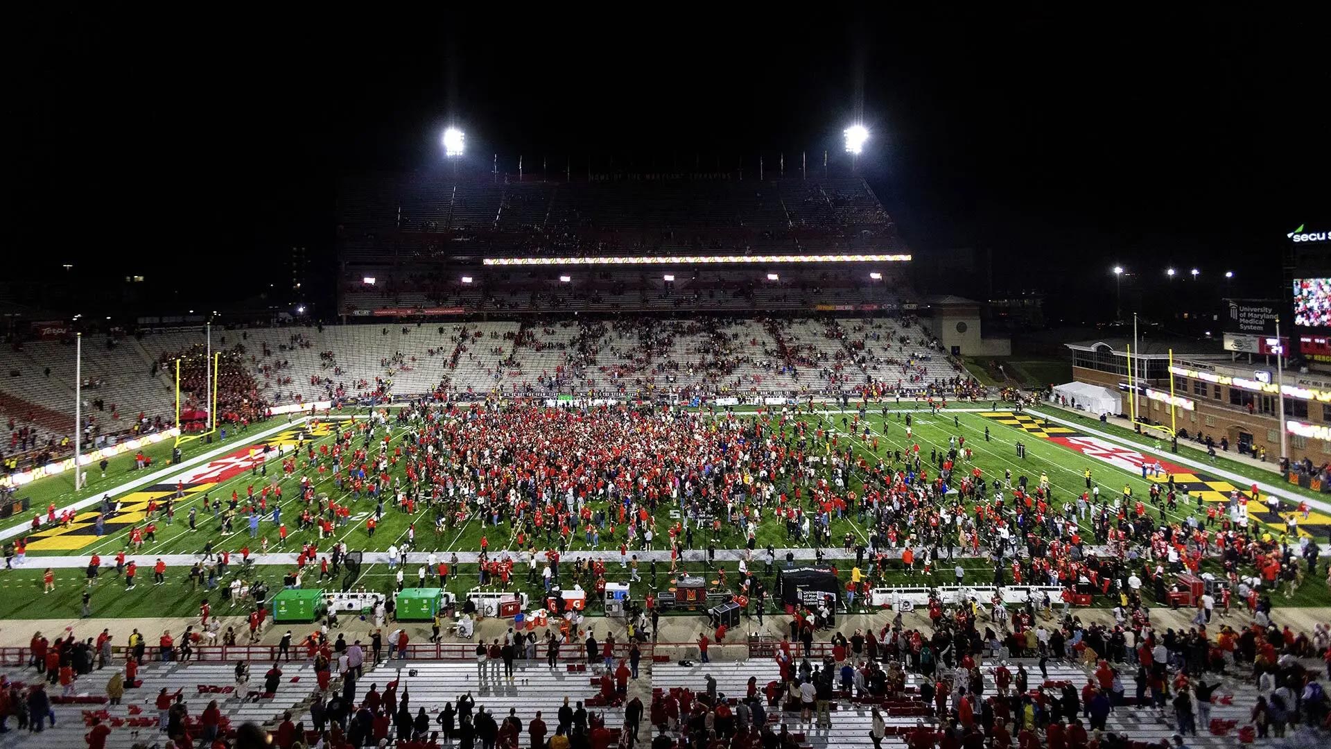 Terps fans storm the field at SECU Stadium on Oct. 19 after the football team’s dramatic 29-28 Homecoming Game victory over USC in the debut meeting between the teams.