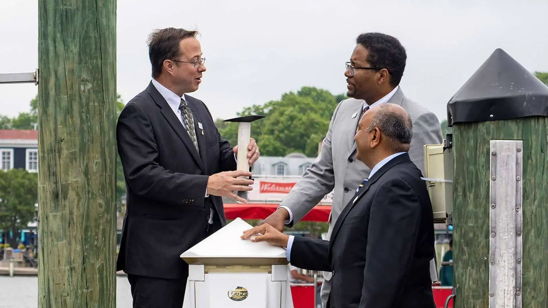 Atmospheric and oceanic science Associate Professor Tim Canty, UMD President Darryll J. Pines and College of Computer, Mathematical, and Natural Sciences Dean Amitabh Varshney discuss the technology behind a newly installed water level sensor that will help Annapolis leaders prepare for future floods. The sensor is part of UMD's Maryland HydroNet, a Grand Challenges Grant-funded project.