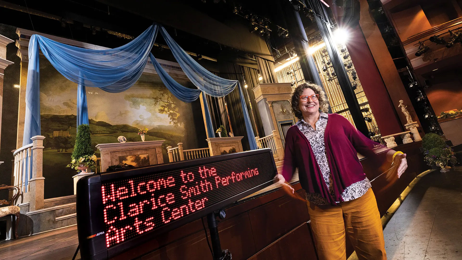 Jill Bradbury, the new director of UMD's School of Theatre, Dance, and Performance Studies, lost her hearing after a childhood illness. Now, her mission is to make performances accessible to everyone who wants to attend, with technological developments like open captioning, displayed at left.