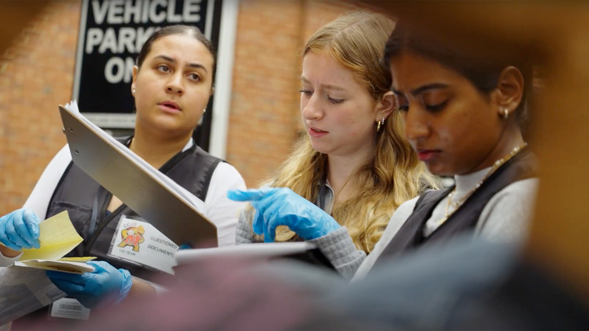 Maryland students review crime dioramas in "Introduction to Criminals" class