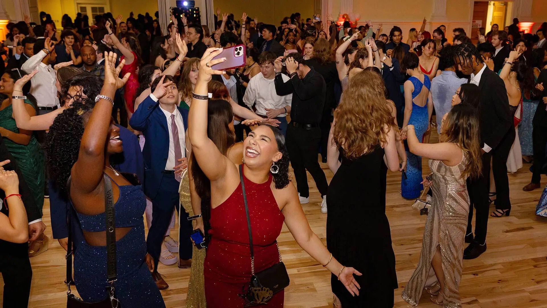 Madison Alvarez '24 takes a video of the dance floor at the prom. She was one of hundreds of students who turned out for a high school tradition this year’s graduating seniors missed in 2020 because of the pandemic