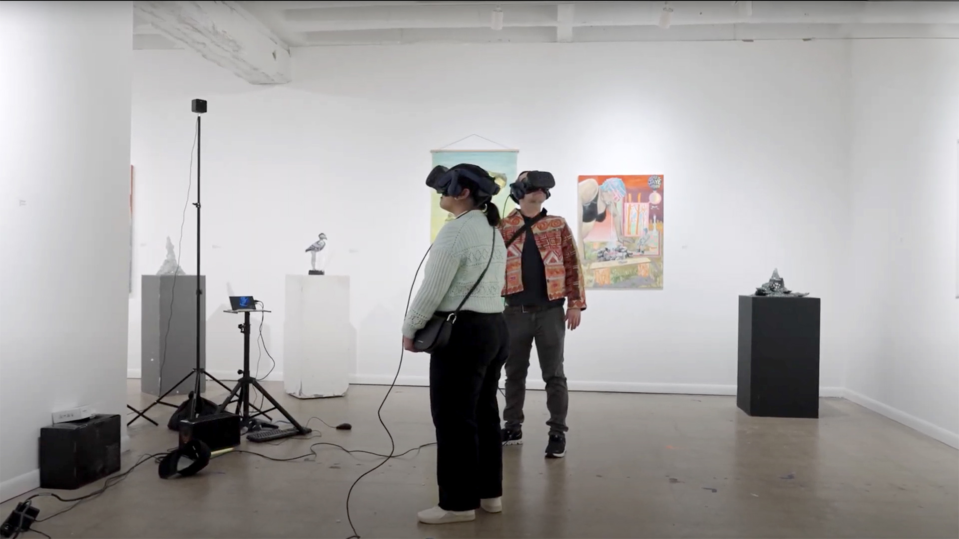 People wear virtual reality headsets to view virtual reality performance