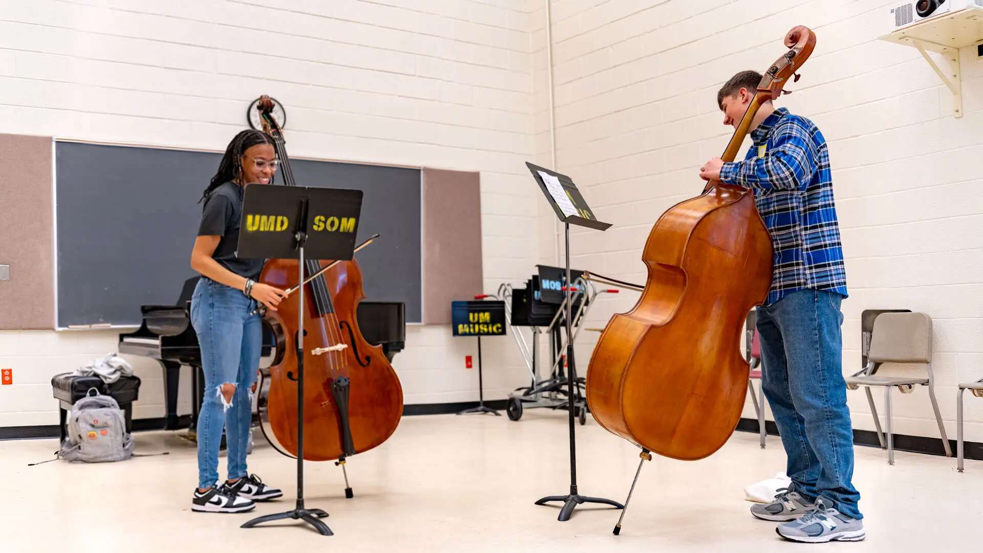 DuVal High School sophomore Conor Rammelsberg receives a bass lesson from Britney Hansford ’26, a bass performance and music education major, at The Clarice as part of the Terrapin Community Music School program.