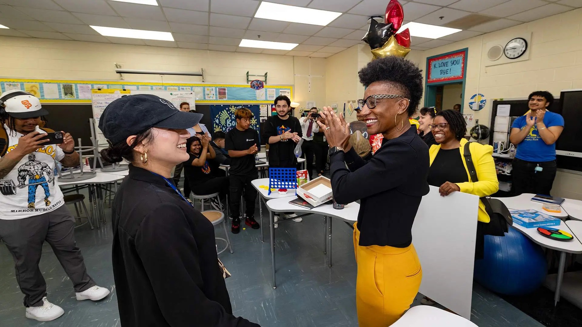 College of Education Dean Kimberly Griffin (right) applauds Jeimy Amaya ’10 on Wednesday for her exceptional work as an English teacher at the International High School at Langley Park