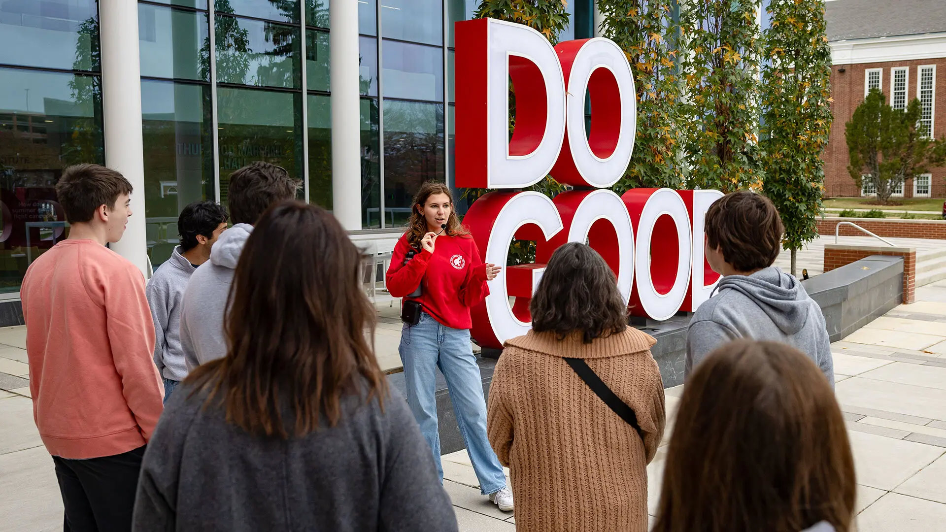 Rachel Donaldson '25 speaks to prospective students and parents outside of Thurgood Marshall Hall. She's part of the new Terp Guides, a group of student employees who lead tour groups at the University of Maryland.